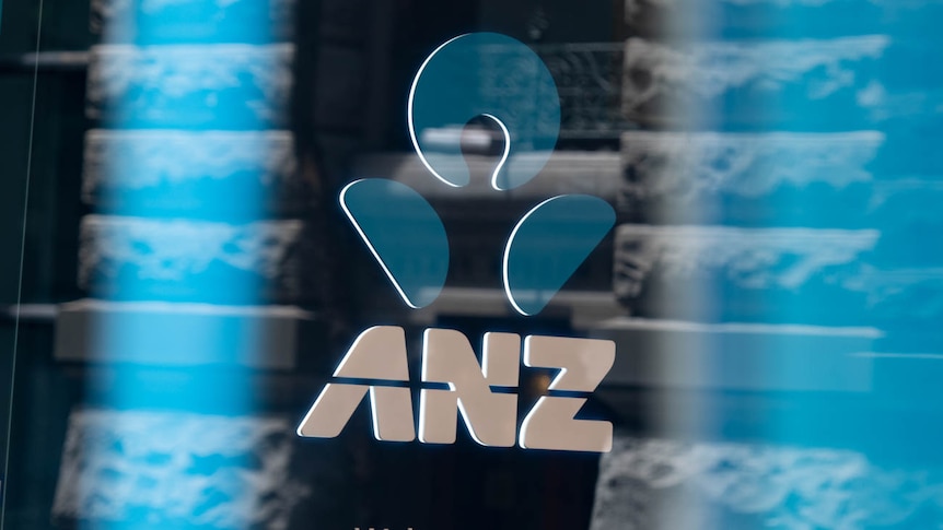 ANZ logo in front of a bank branch.