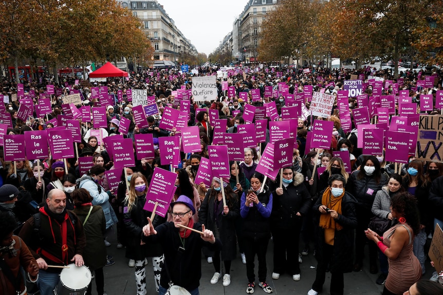 Men and women march in the thousands in France with pink placards and posters to protest violence against women.
