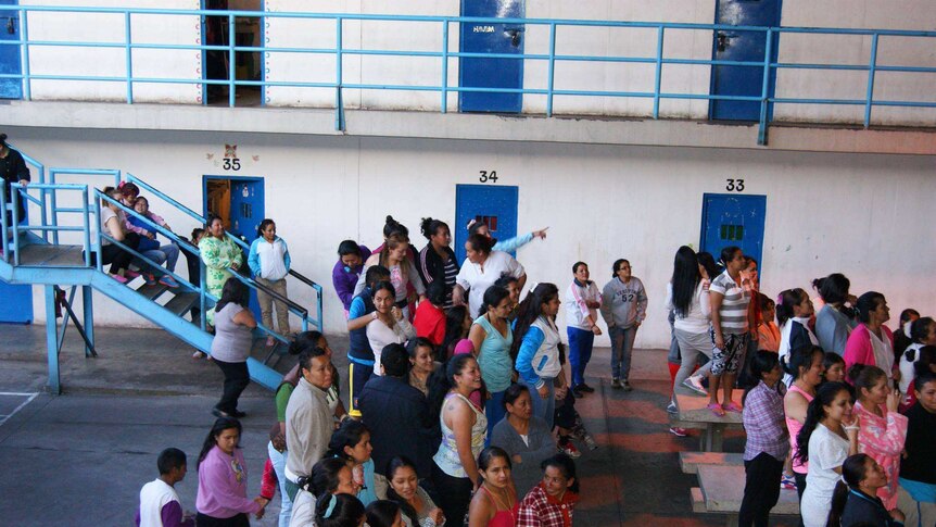 Women stand in a common area inside the El Buen Pastor prison.