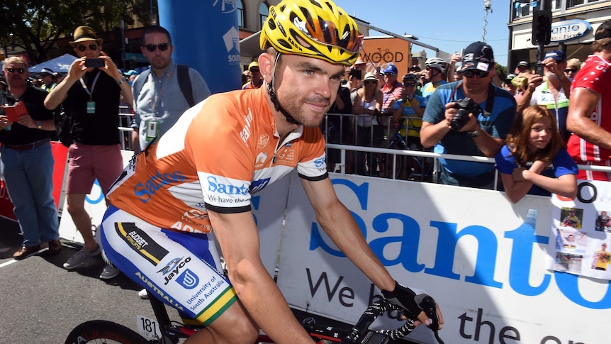 Australian rider Jack Bobridge sits on his bike with fans behind him at the start of Stage 3 of the Tour Down Under.