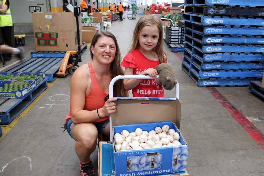 Emma Tozer and Pippa Juster with a box of mushrooms.