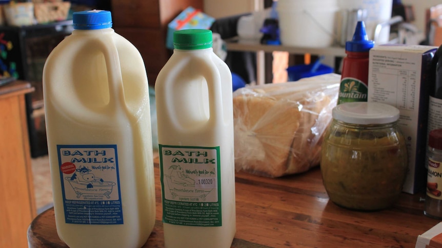 Bottles of bath milk sitting on a table