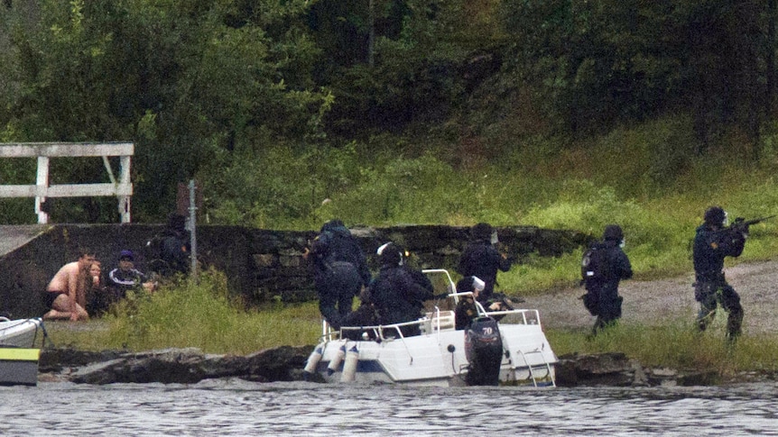 A SWAT team take aim as they arrive on the island of Utoya.