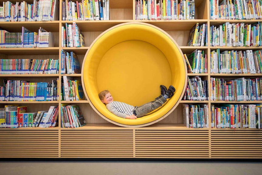 A child lying inside a circular lounge.