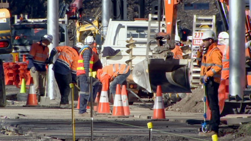 Construction workers on St Kilda Road on July 6, 2017, as part of the Metro Tunnel works.