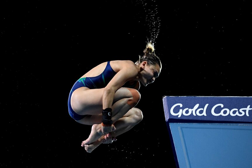 Melissa Wu curled in a ball, mid-air during 10m dive