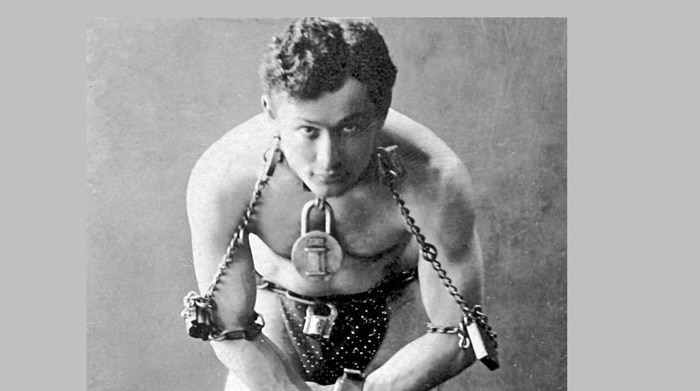 Harry Houdini, black and white full-length portrait, standing, facing front, in chains, circa 1899