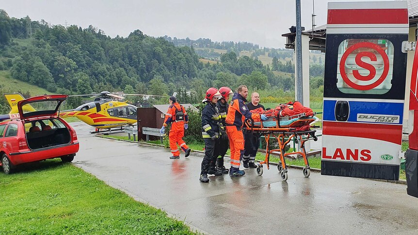 rescue crews tend to a person in a stretcher
