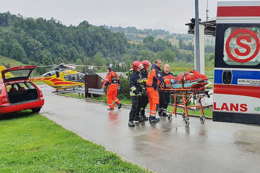 rescue crews tend to a person in a stretcher