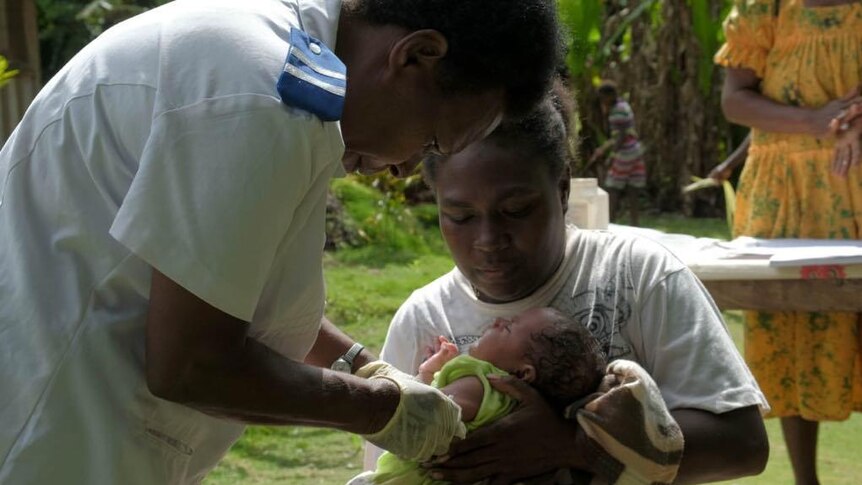 A nurse in Vanuatu vaccinates a baby using medicine delivered by drone.