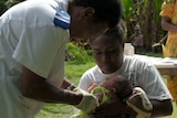 A nurse in Vanuatu vaccinates a baby using medicine delivered by drone.