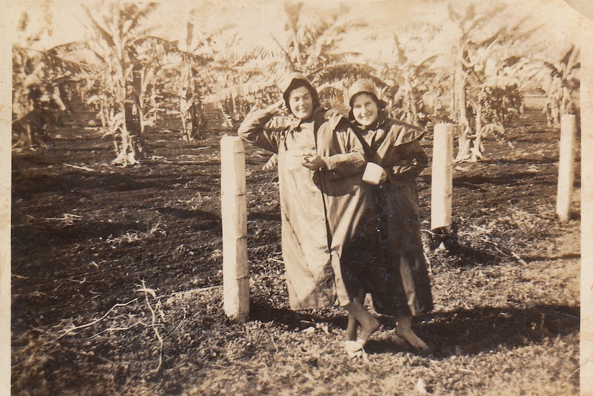 B&W photo of two women farming.