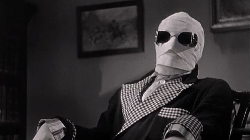 A black and while image of a man wrapped in bandages wearing sunglasses