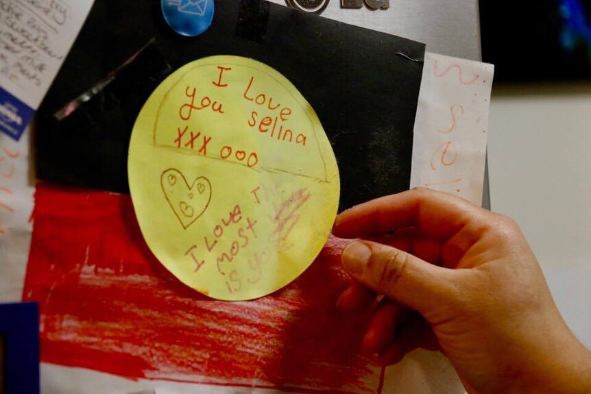 Paper artwork made by a child of an Aboriginal flag with the words 'I love you Selina'