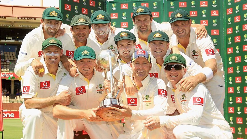 Michael Clarke and his team celebrate with the Border-Gavaskar Trophy after victory in Adelaide.