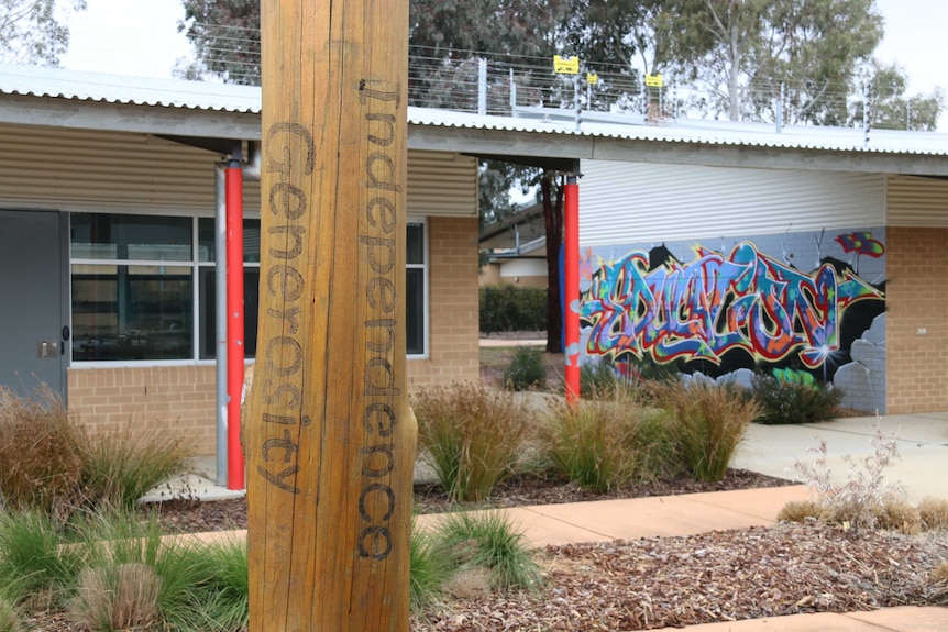 A pole with the words 'Independence, Generosity' engraved on it in the yard of Bimberi Youth Justice Centre.
