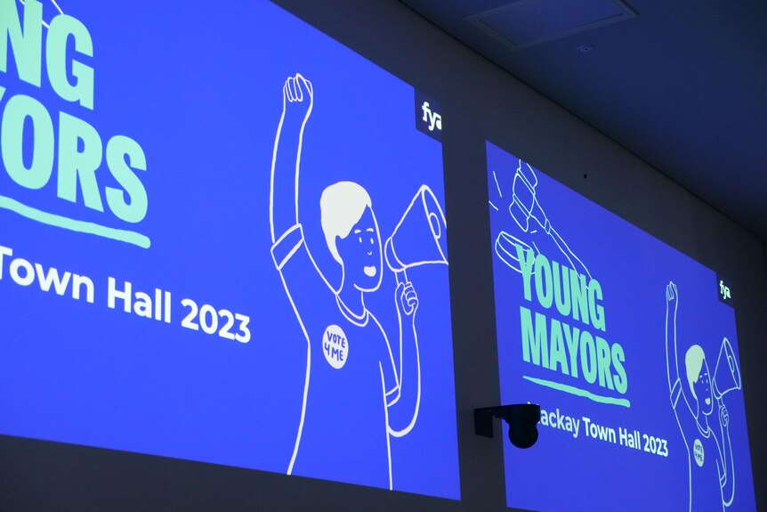Screen projected onto a wall saying 'young mayors.'