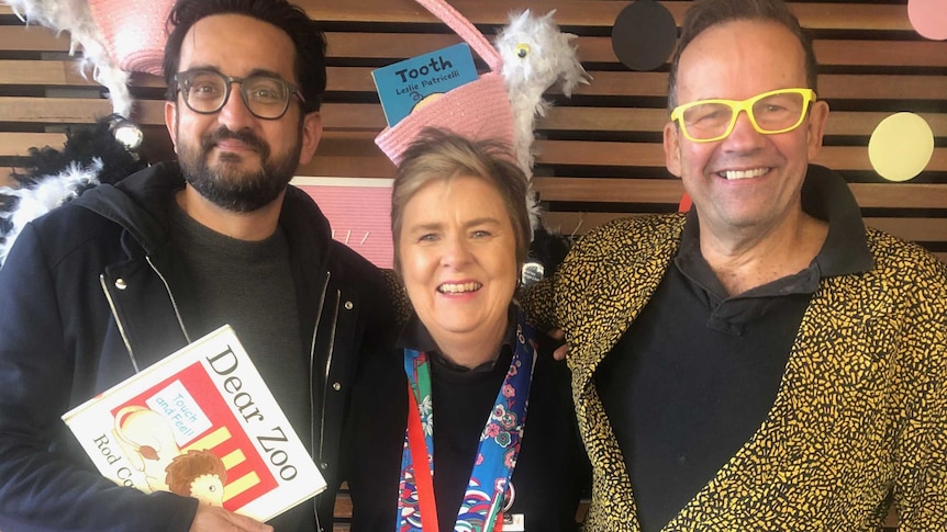 Sami Shah, Monica Dullard, and Cr Dick Gross stand together at a storytime event at the Emerald Hill library in South Melbourne