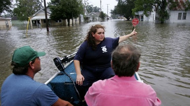 Surveying the damage ... a Louisiana resident directs volunteers to her flooded home