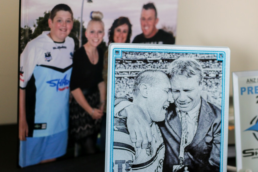 A photo of past and present Cronulla captains crying sits alongside a family portrait.