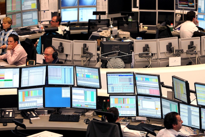 Brokers work in the stock exchange in Frankfurt.