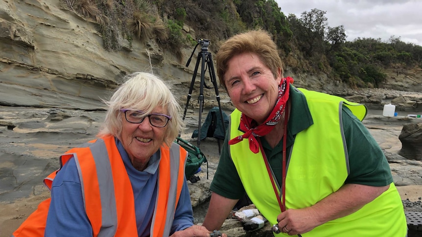 Two women at the beach during a palaeontology dig