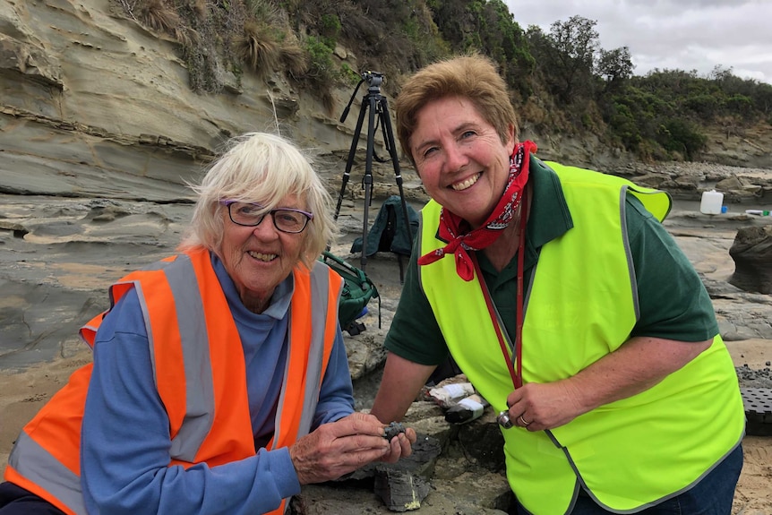 Two women at the beach during a palaeontology dig