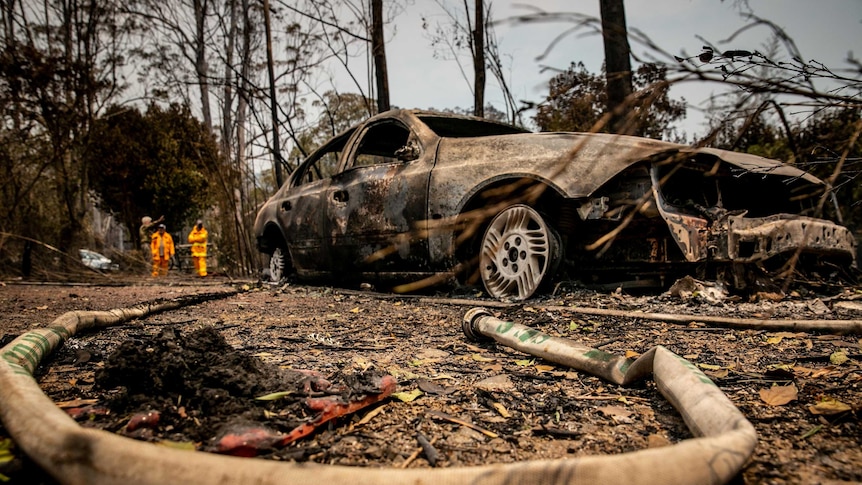 A burnt out car after a bushfire.