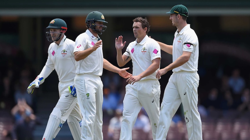 Steve O'Keefe is congratulated after taking the wicket of Denesh Ramdin