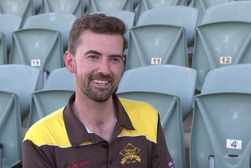 A man sits in a stadium