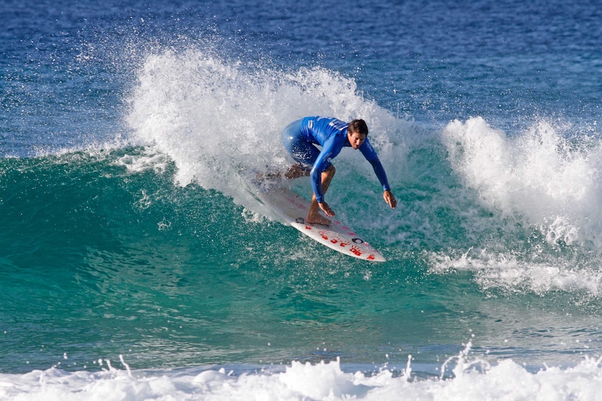 A surfer carving a turn on a wave.