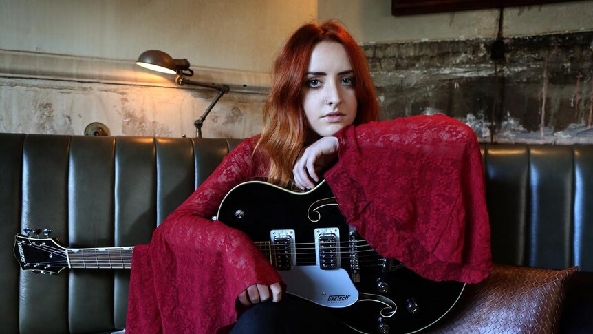 Press photo of alt-country singer Tori Forsyth with guitar