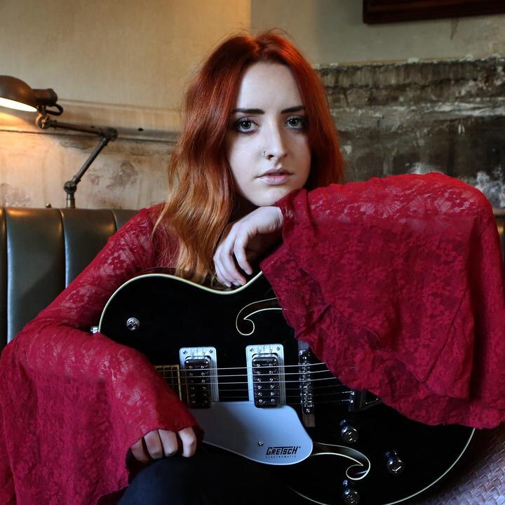 Press photo of alt-country singer Tori Forsyth with guitar