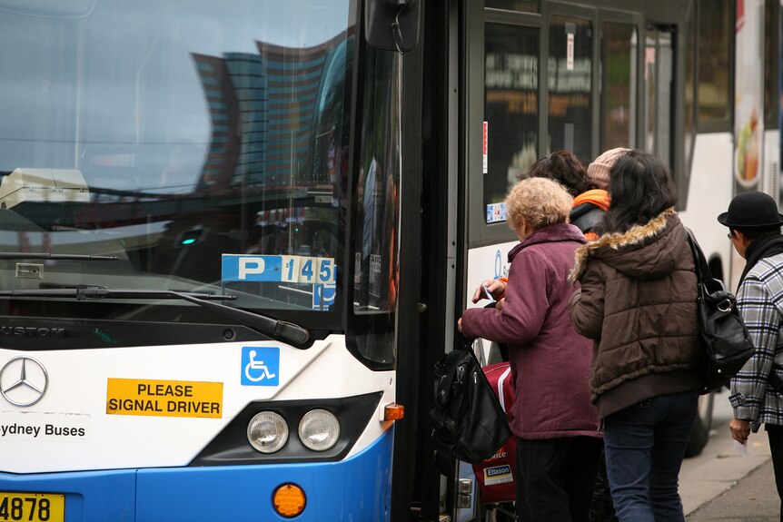 people getting on a bus