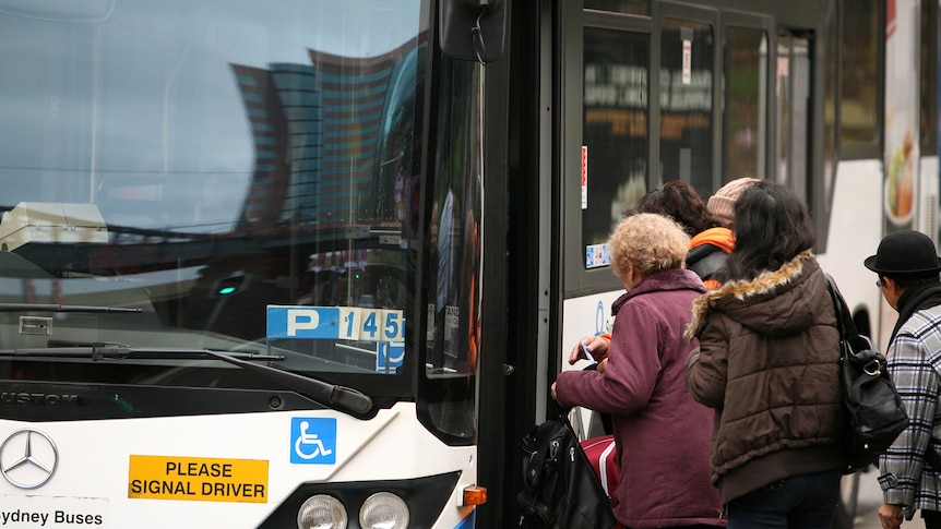 people getting on a bus