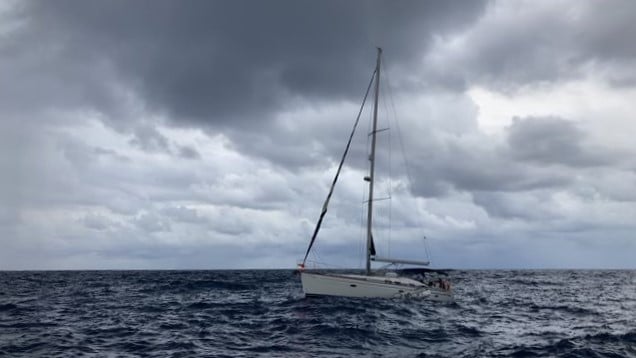 A yacht in the ocean with grey skies