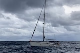 A yacht in the ocean with grey skies