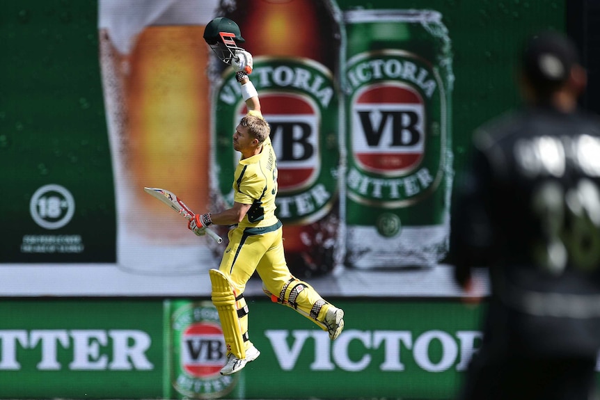 David Warner with VB advertising behind him