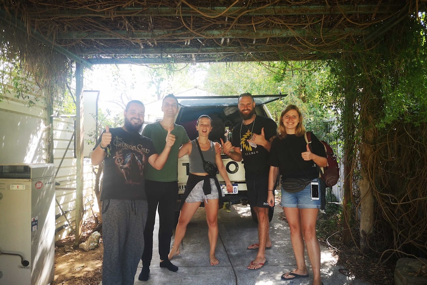 Backpackers at the back of a four wheel drive vehicle