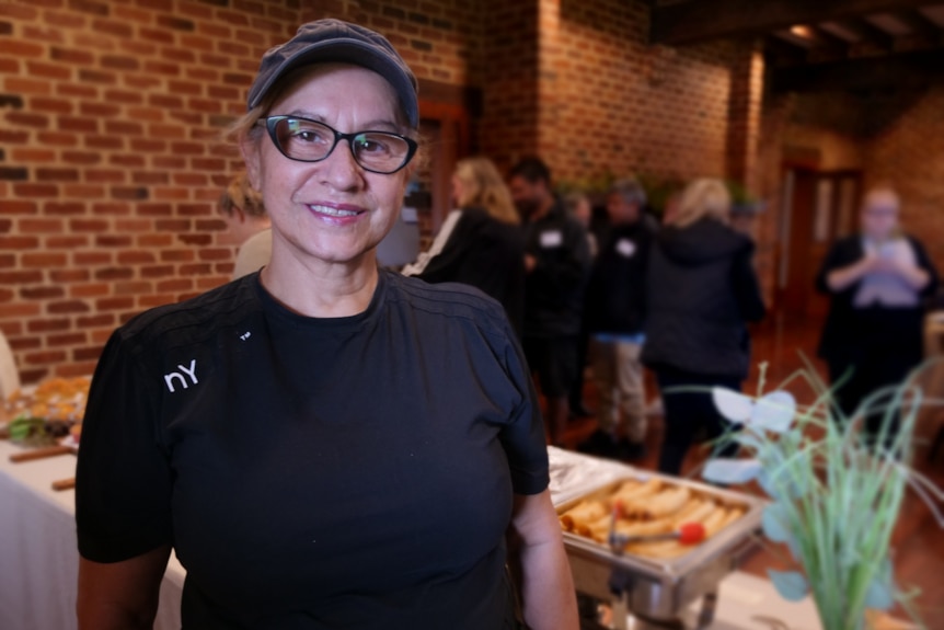 Teena Forrest in front of a catering table