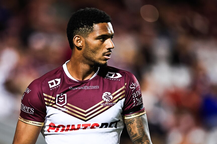 NRL player Jason Saab looks over his left shoulder during a warm up before a night match for Manly