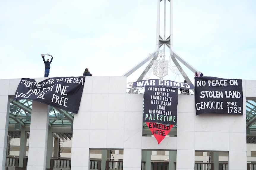 Black banners wave along the front of parliament.