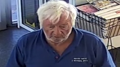 A CCTV picture of a white-haired man wearing a blue shirt.