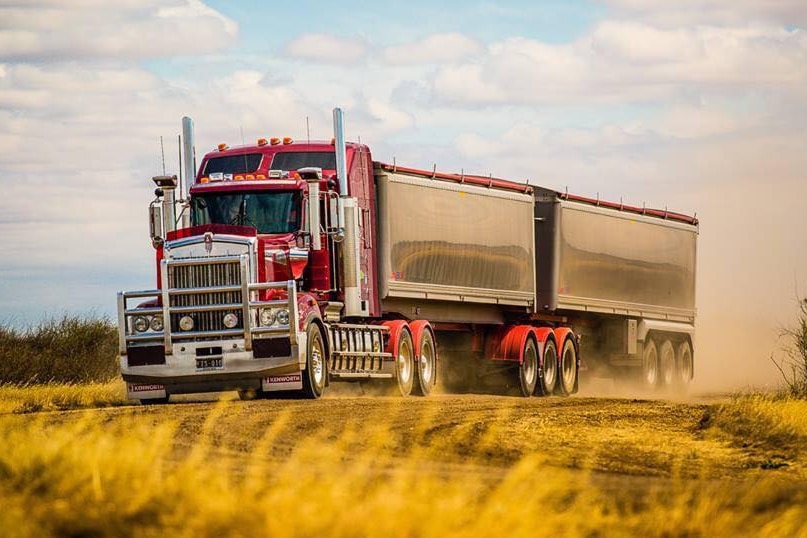 a B-Double truck drives down a road