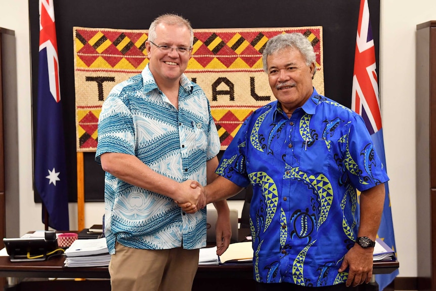 Scott Morrison, left, wears a patterned shirt as he stands next to Enele Sopoaga in another patterned shirt.