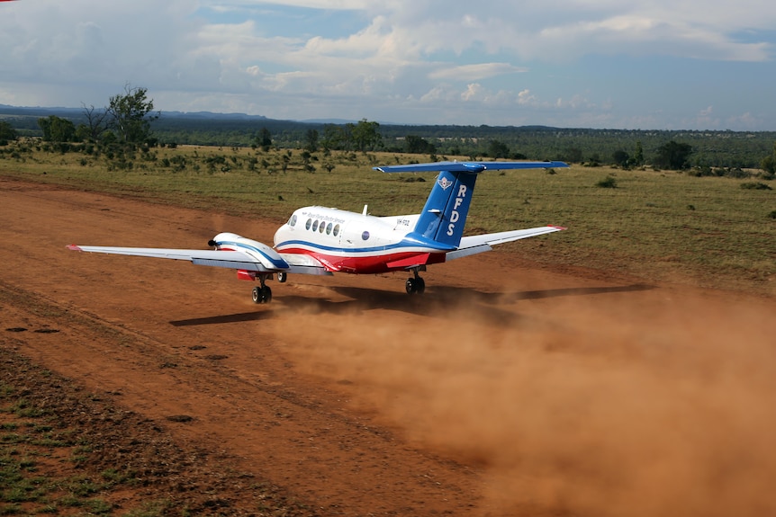Light plane on dusty dirt runway