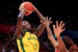 Australia's Ezi Magbegor shoots as a player puts their arms up to defend. 