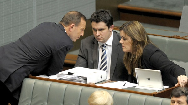 Tony Abbott speaks with advisers