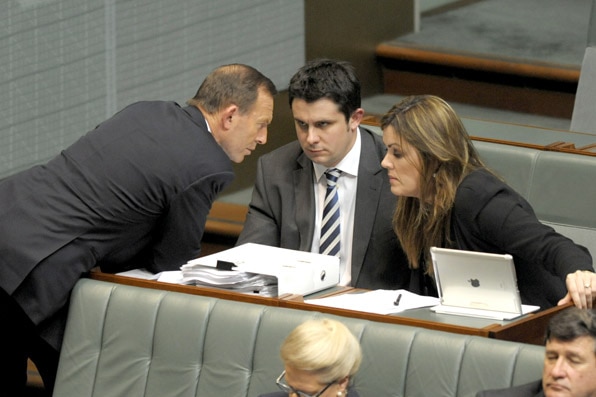 Tony Abbott speaks to advisers Peta Credlin and Andrew Hirst in 2013.