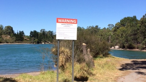 Warning sign in front of a natural swimming pool in Collie Shire
